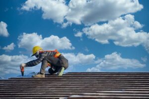 Clean gutters line a home’s roof edge while a downspout directs rainwater away from the foundation.